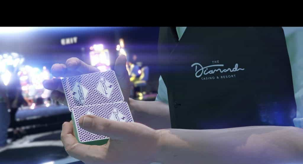 GTA Casino dealer shuffles a deck of cards featuring prominent Diamond Casino logo.