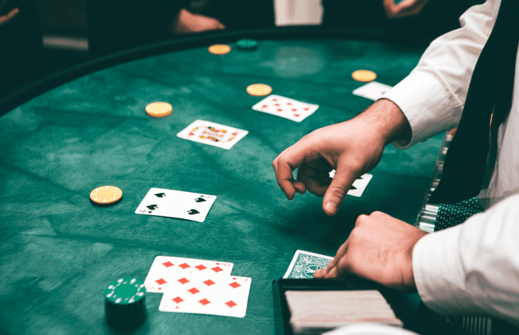 A table in a casino with people playing blackjack.