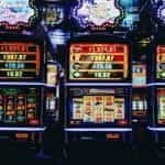 Casino interior with slot machines and colorful lights.