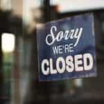 A closed sign in a shop door.