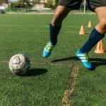 A footballer training on a pitch.