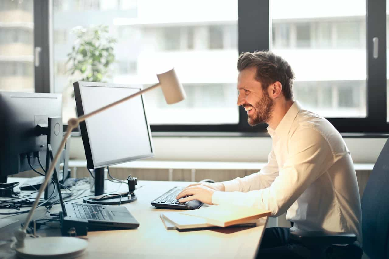 A business man in an office using a computer.