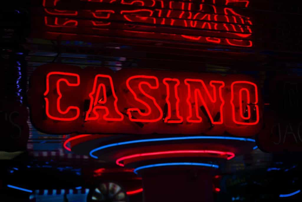 A sign for a casino in bright neon red lighting. 